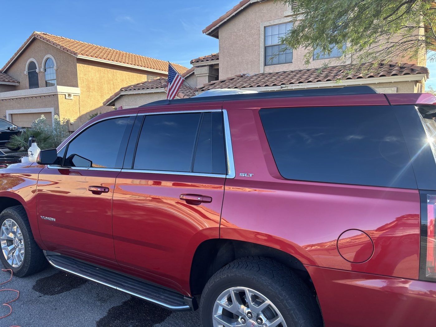 Red GMC Yukon with tinted windows